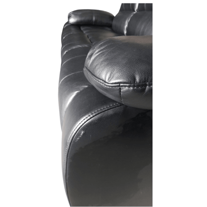 Close-up of a black leather sofa with visible stitching on a white background