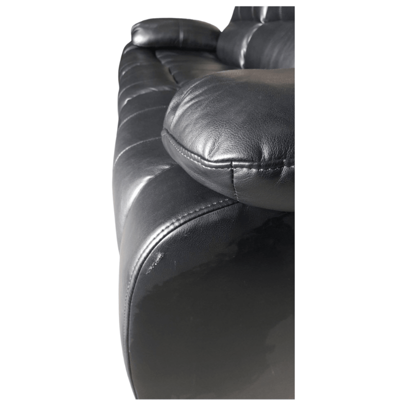 Close-up of a black leather sofa with visible stitching on a white background