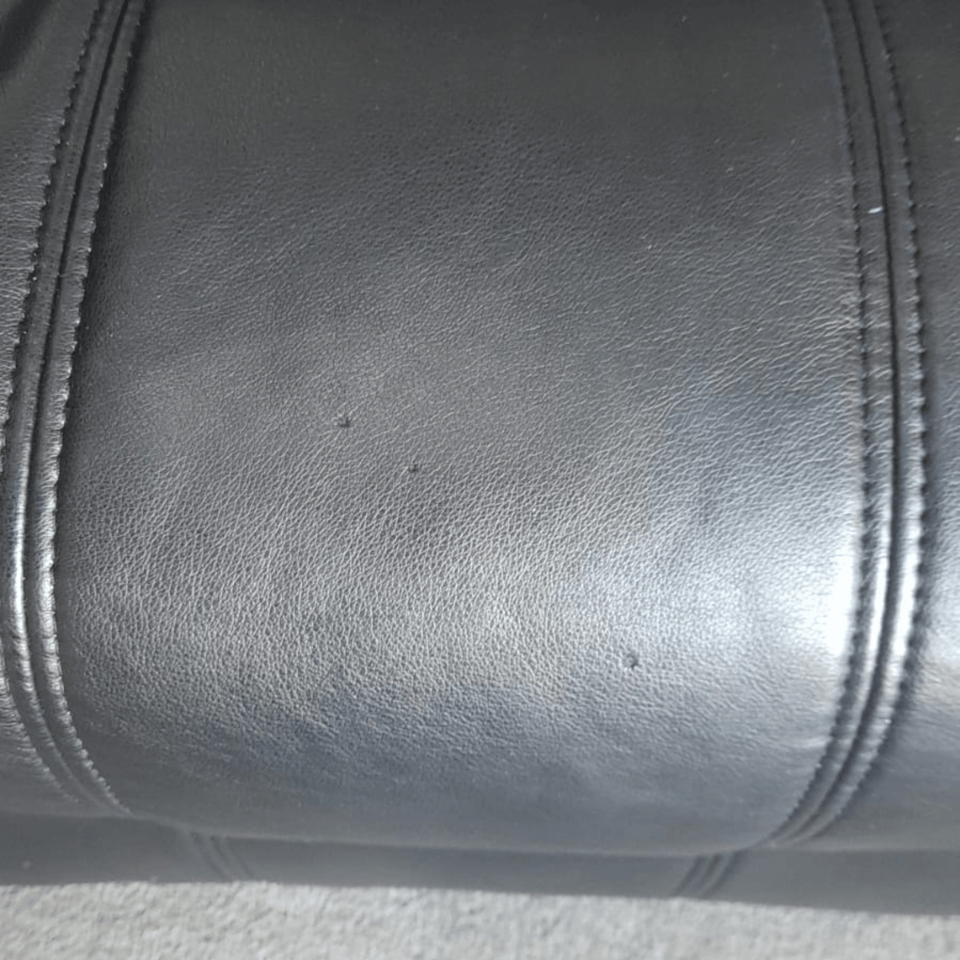 Close-up of black leather texture with stitching details