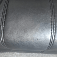 Close-up of black leather texture with stitching details