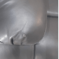 Close up of the armrest on the Valerie grey leather 3-seater sofa, highlighting the smooth texture and stitching detail    