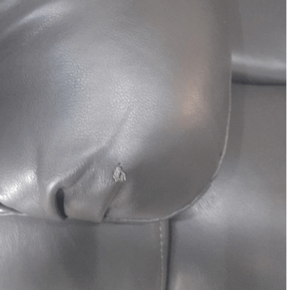 Close up of the armrest on the Valerie grey leather 3-seater sofa, highlighting the smooth texture and stitching detail    