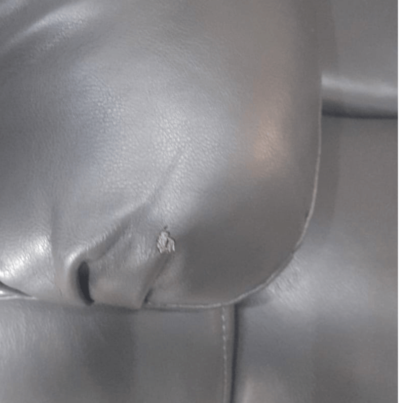 Close up of the armrest on the Valerie grey leather 3-seater sofa, highlighting the smooth texture and stitching detail    