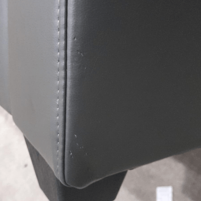 close up of grey leather sofa of marks on corner.