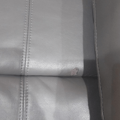  Close-up detail of the Valerie grey leather armchair showcasing texture