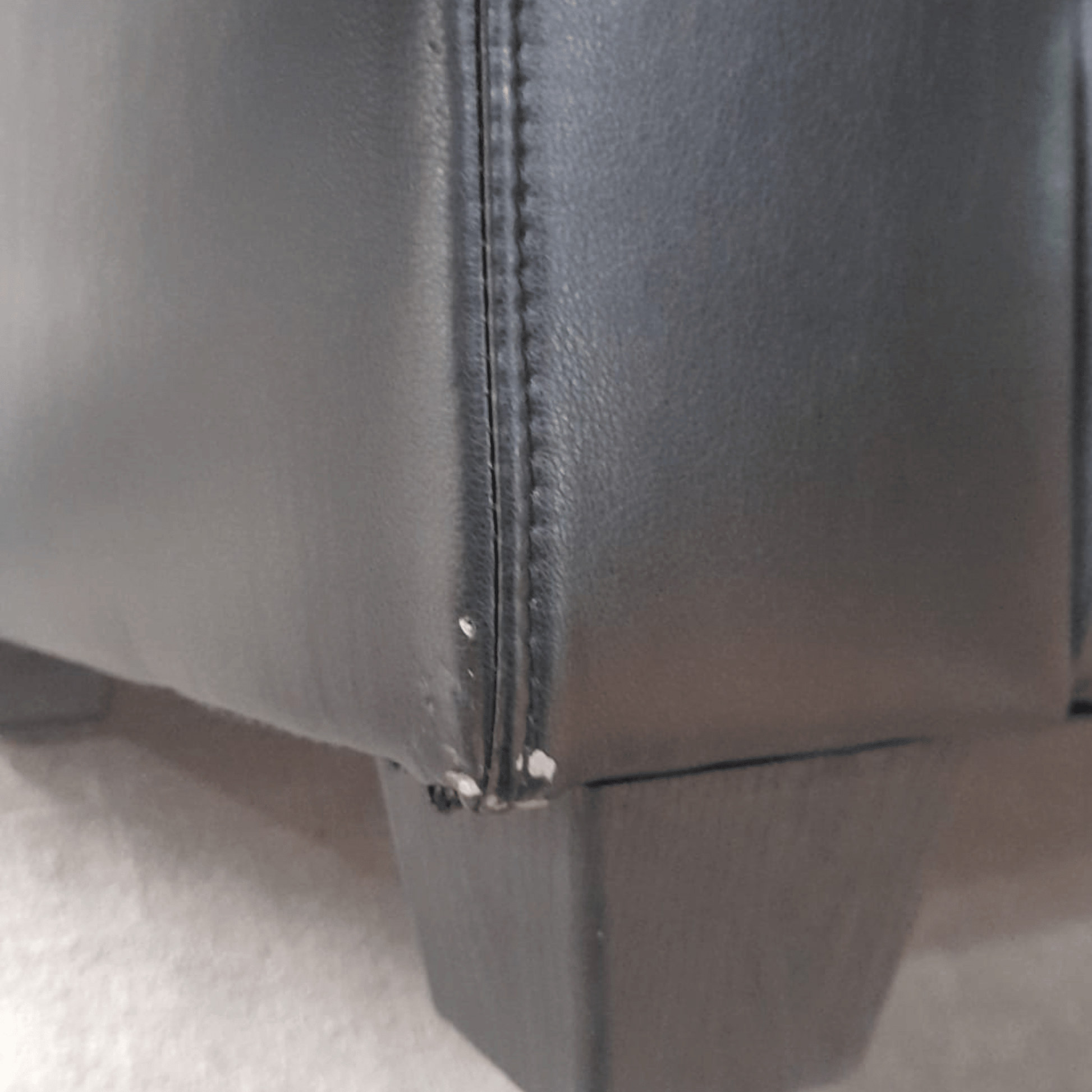 close up of Valerie black 3 seater showing scuffs