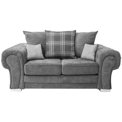 Gray sofa with plaid pillow on a white background