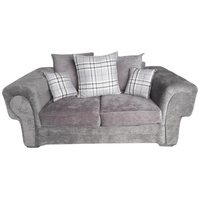 Gray sofa with plaid cushions on a white background
