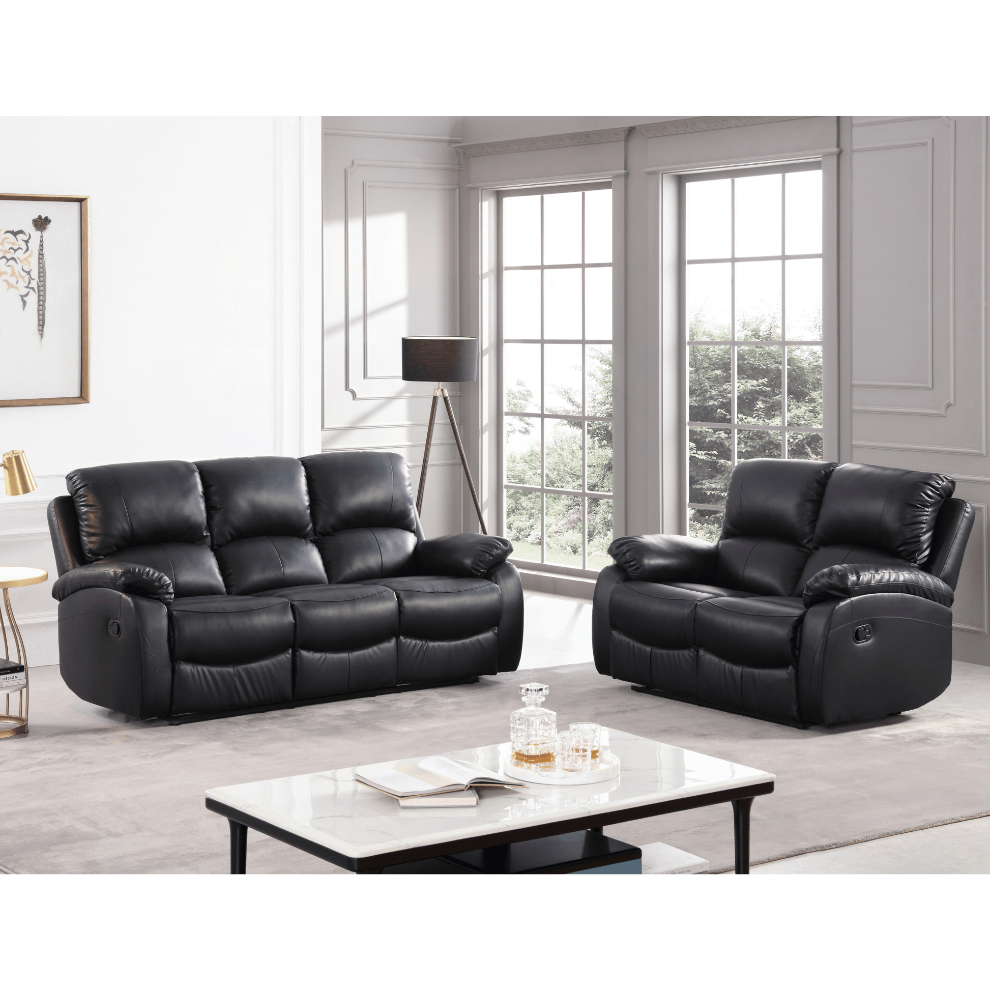 Black leather recliner sofa set in a living room with a coffee table and decor items.