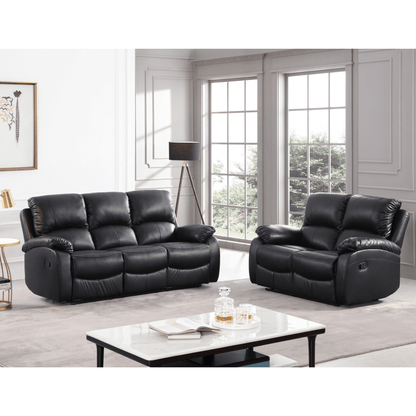 Black leather recliner sofa set in a living room with a coffee table and decor items.
