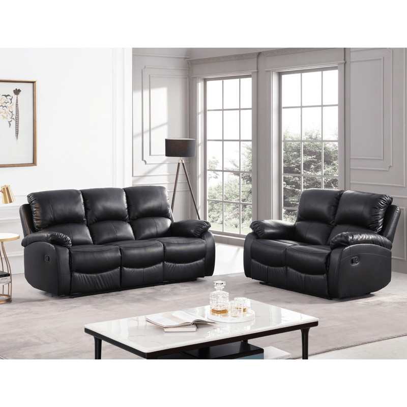 Black leather recliner sofa set in a living room with a coffee table and decor items.