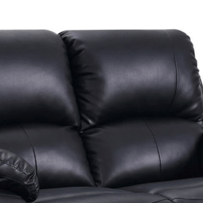 Close-up of a black leather sofa with a white background