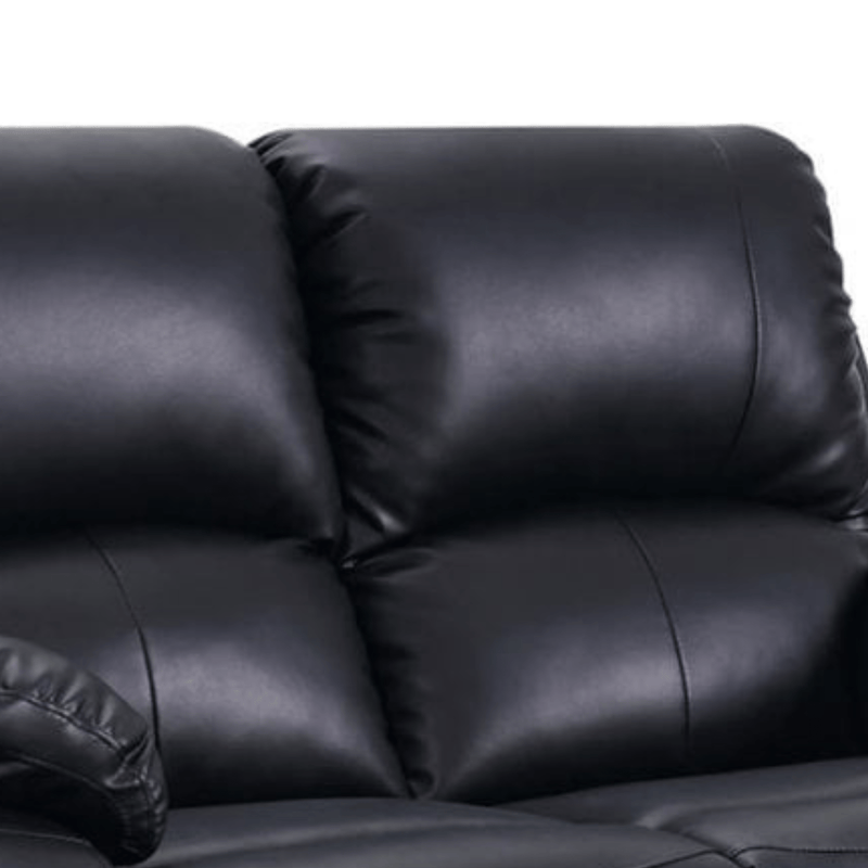 Close-up of a black leather sofa with a white background