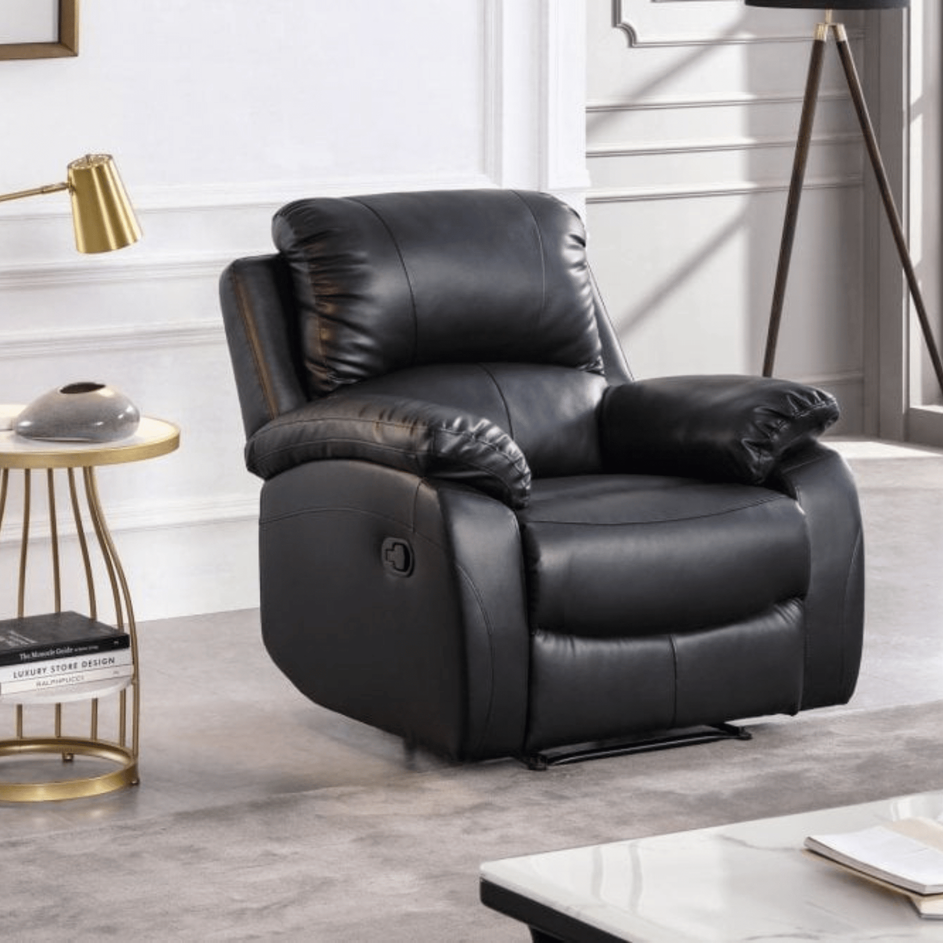 Black leather recliner chair in a living room setting with a side table and lamp.