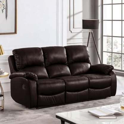 Brown leather sofa in a living room setting with a lamp and window in the background.