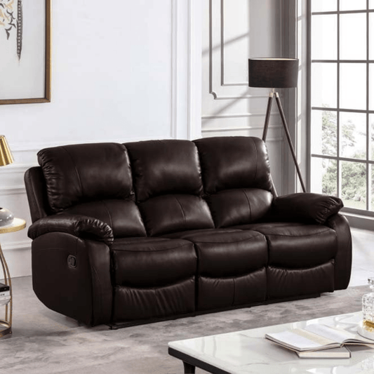 Brown leather sofa in a living room setting with a lamp and window in the background.