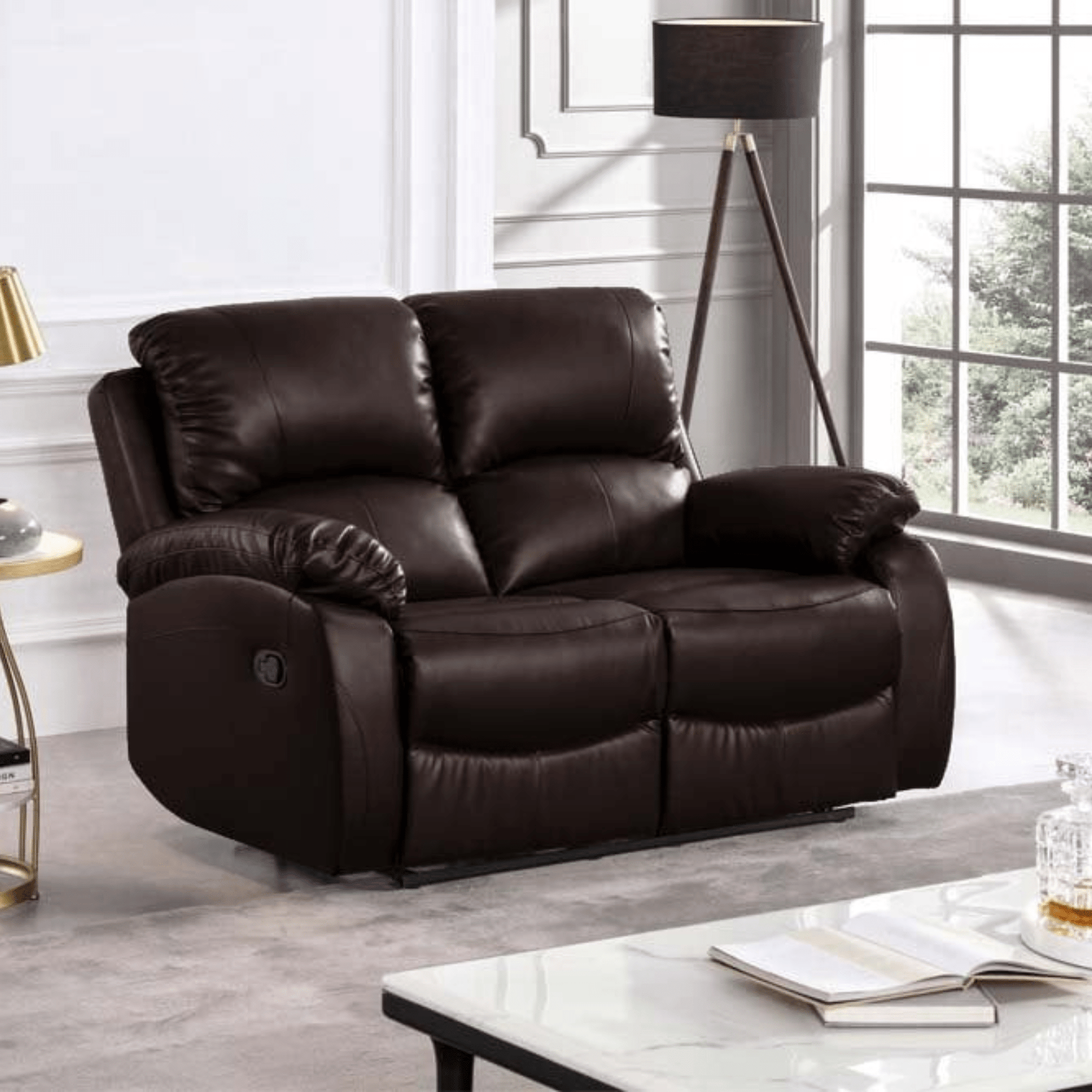 Brown leather recliner sofa in a living room setting with a lamp and table.