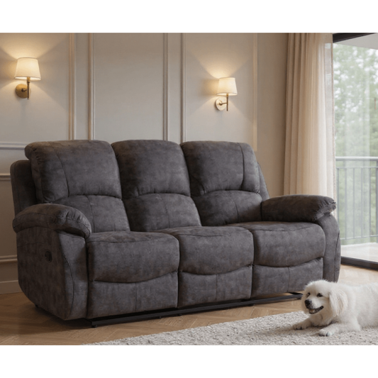 Gray sofa in a living room with a dog sitting on the floor.