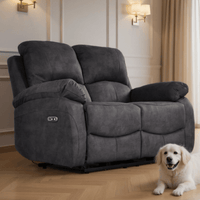 Gray recliner sofa in a living room with a white dog sitting next to it.