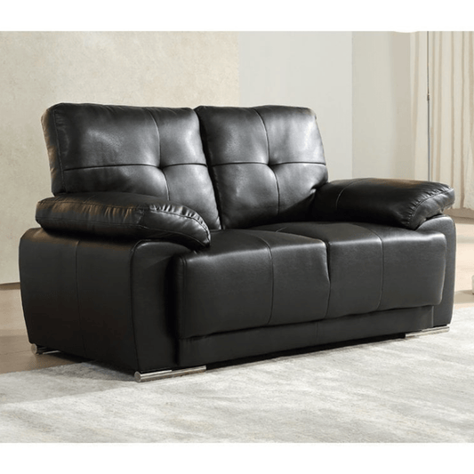 Black leather sofa in a room with light-colored walls and floor.