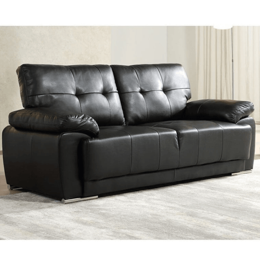 Black leather sofa in a room with light-colored walls and flooring