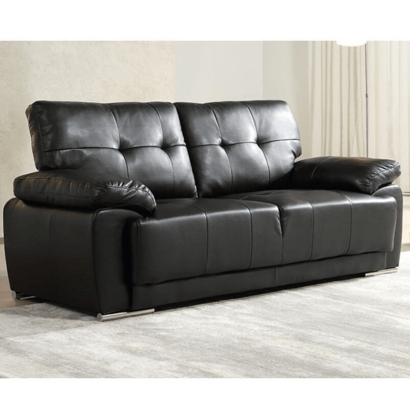Black leather sofa in a room with light-colored walls and flooring