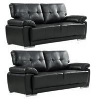 Two black leather sofas on a white background