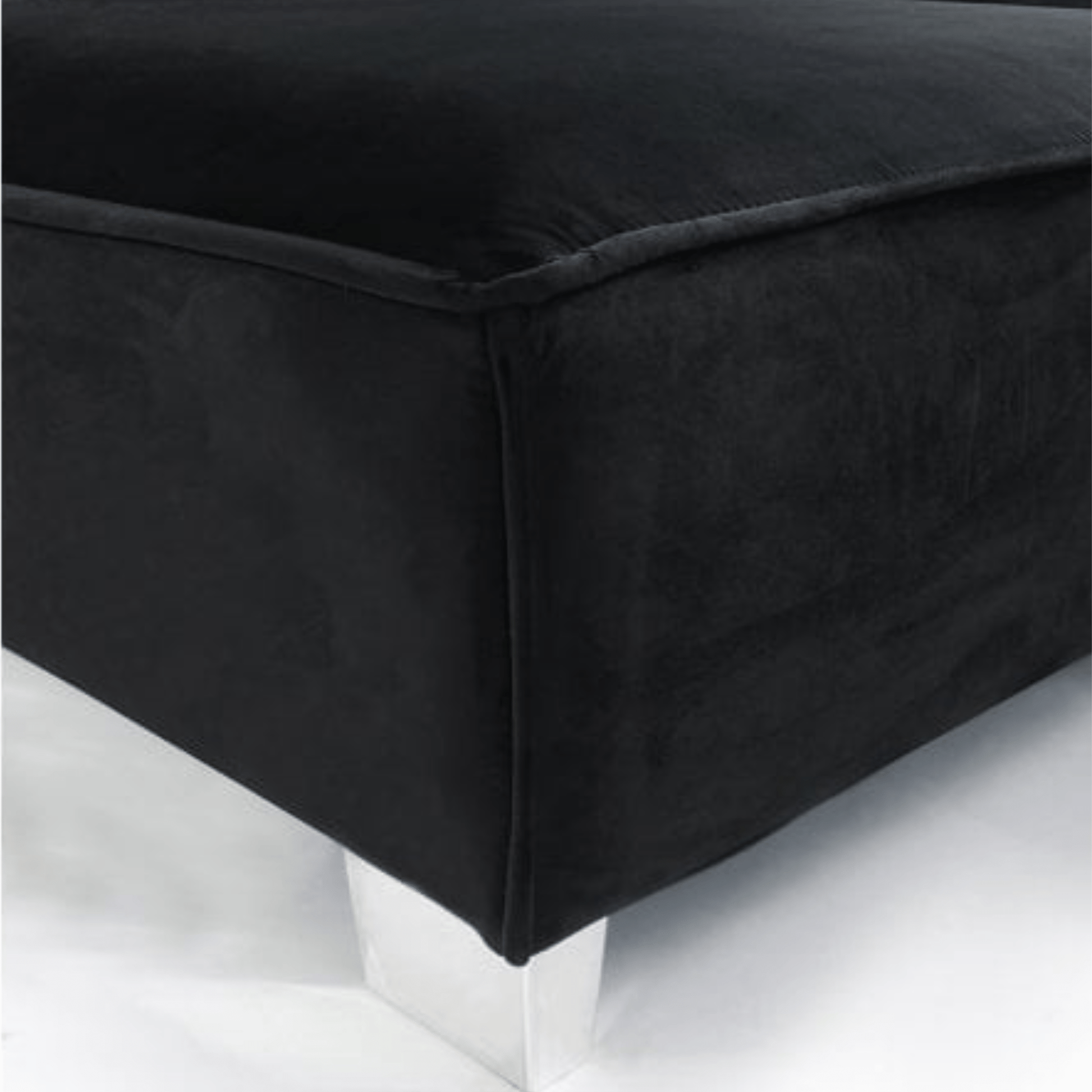 Black upholstered ottoman on a white background