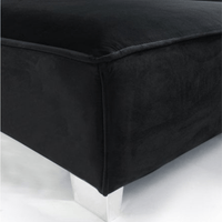 Black upholstered ottoman on a white background