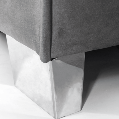 Gray upholstered chair with metallic legs on a white background
