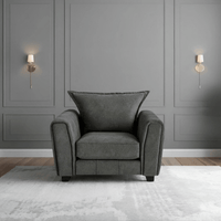 Somerford Grey Armchair front facing in a modern living room setting, grey fabric with soft upholstery and stylish design