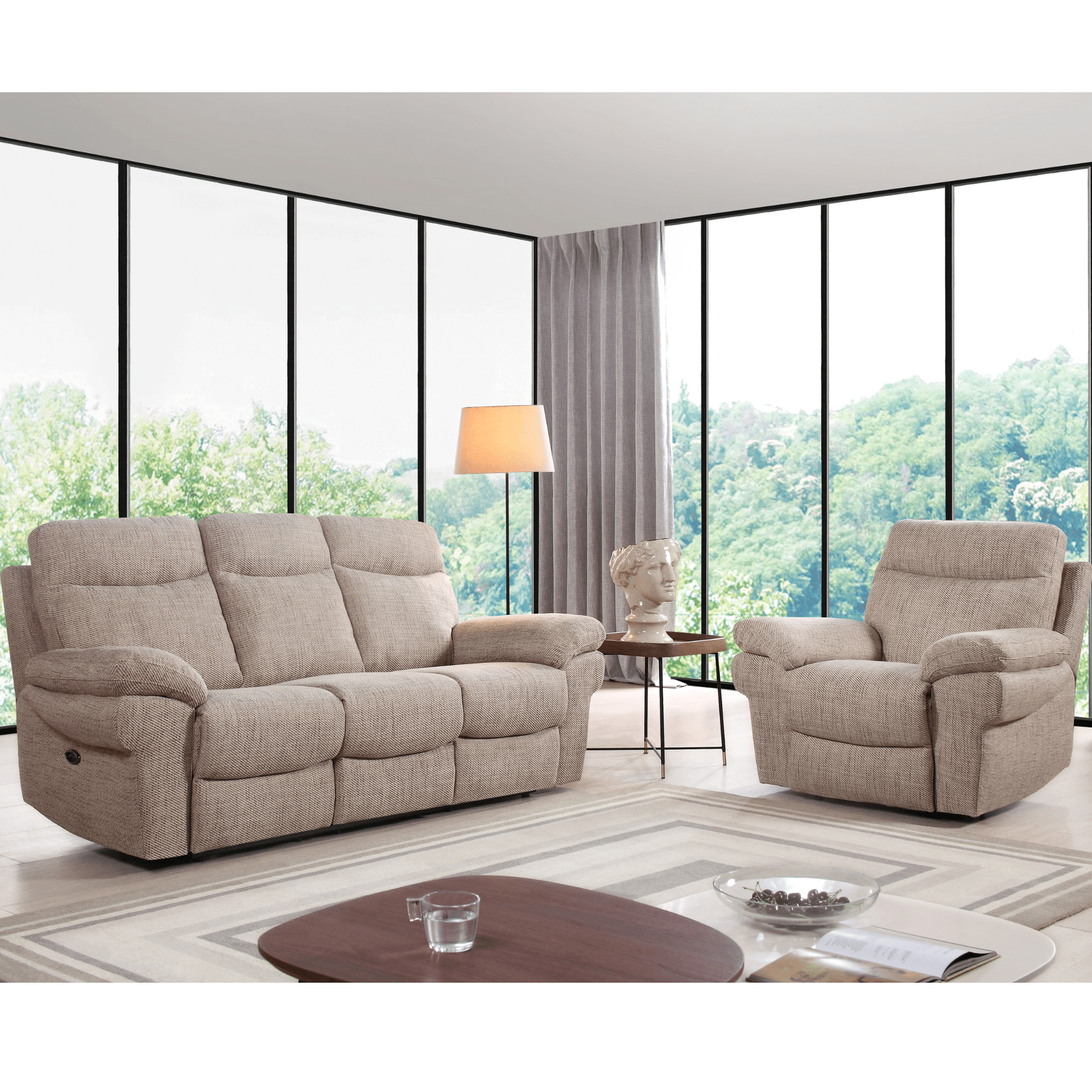 Beige recliner sofa and armchair in a living room with large windows.