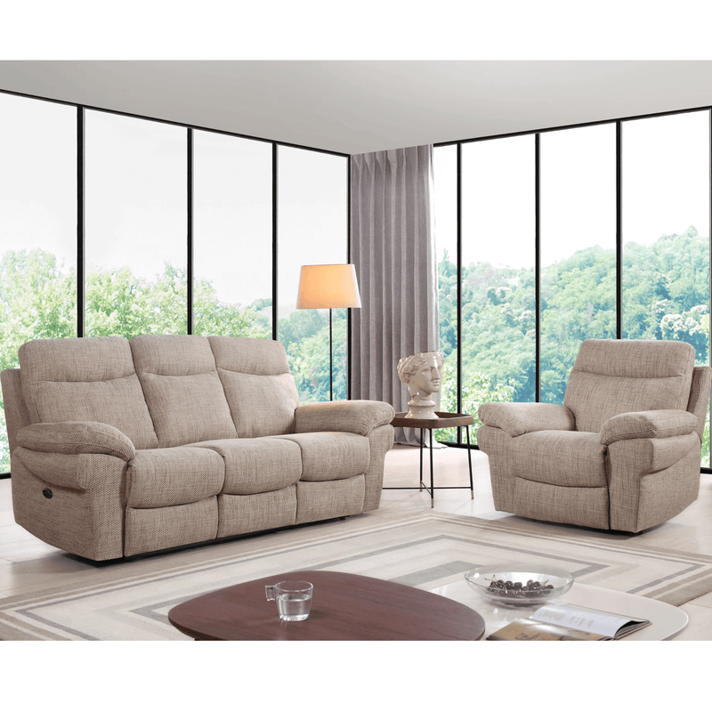 Beige recliner sofa and armchair in a living room with large windows.