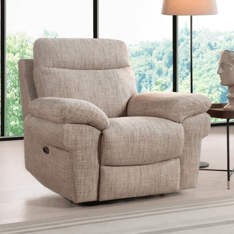 Beige recliner chair in a room with large windows and a lamp.