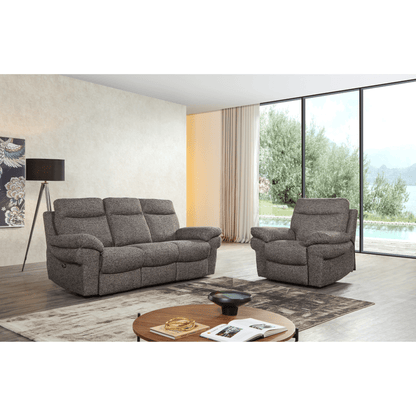 Gray sofa and armchair in a modern living room with large windows.
