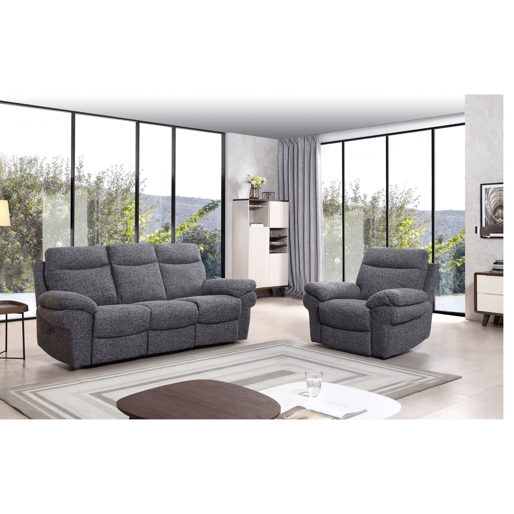 Gray sofa and armchair set in a modern living room with large windows.