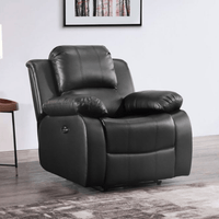 Black leather recliner chair in a room with a framed picture on the wall.