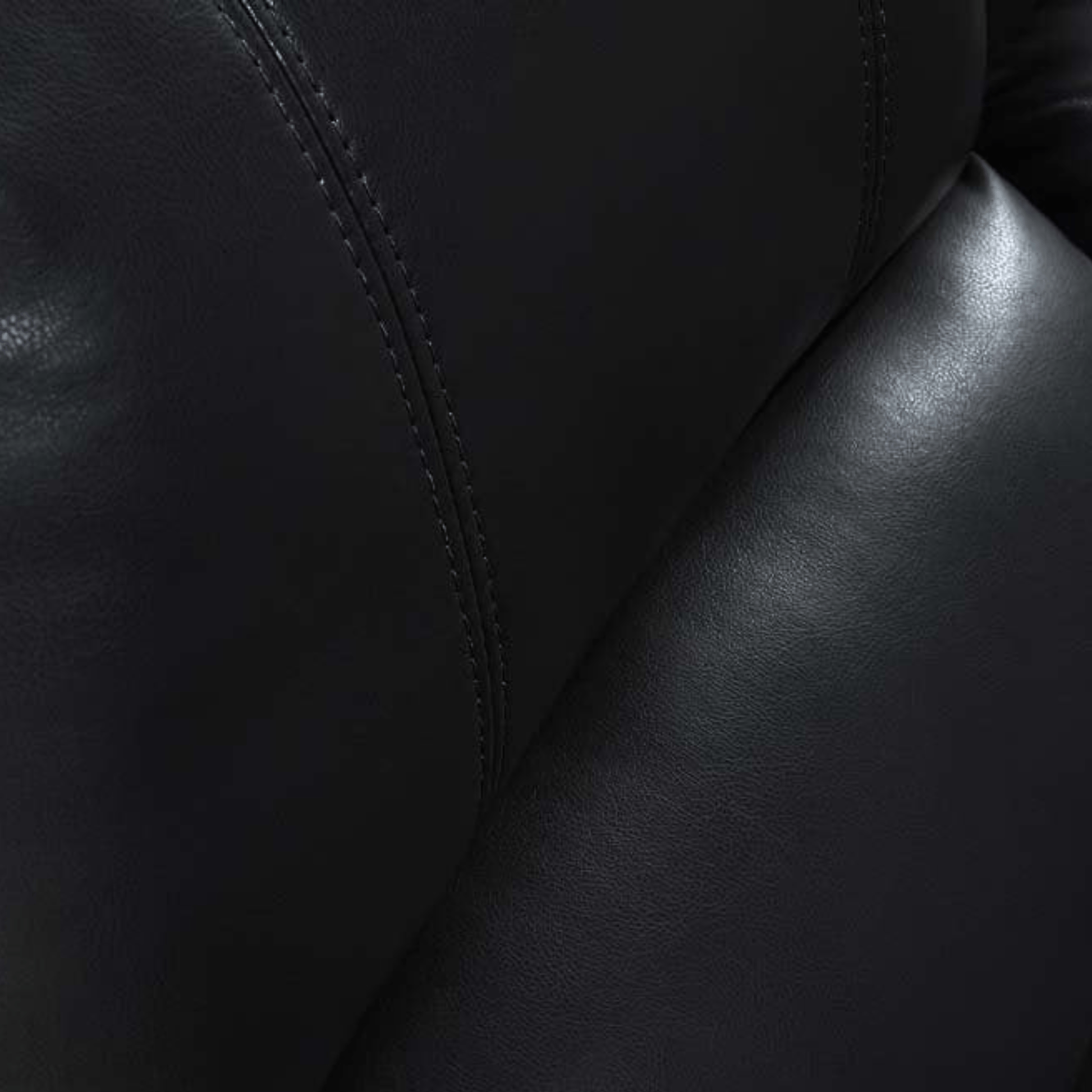 Close-up of black leather texture with visible stitching