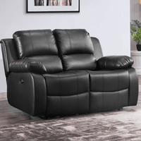 Black leather reclining sofa in a room with a plant and framed picture on the wall.