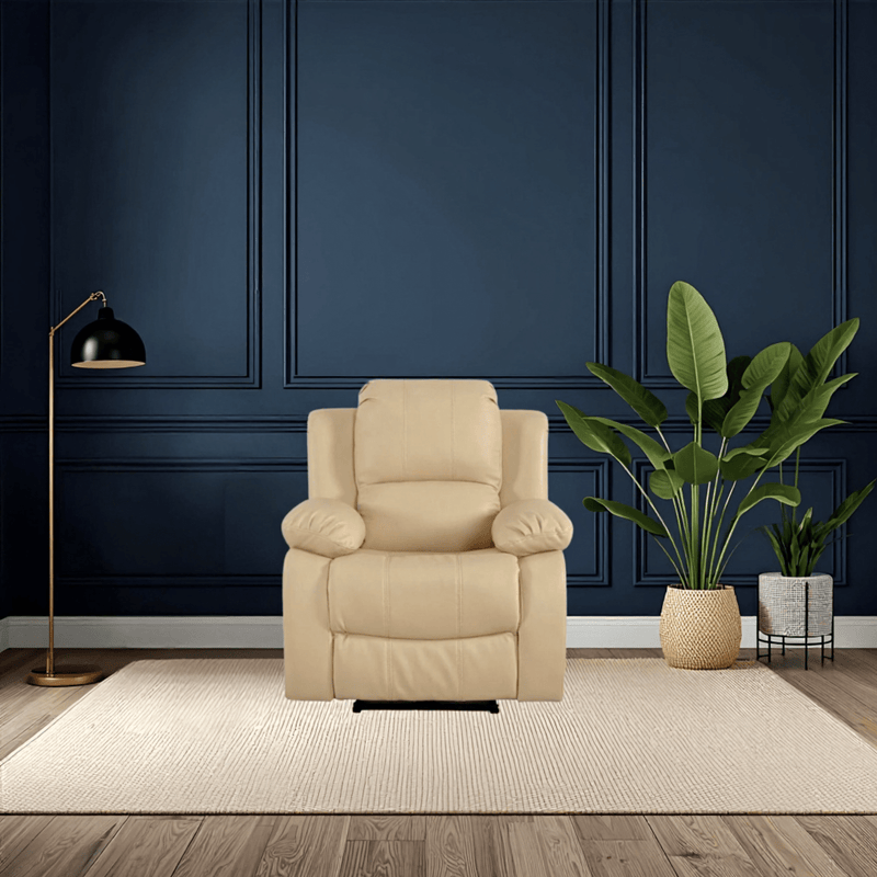 Beige armchair in a room with dark blue paneled walls, a floor lamp, and a plant.