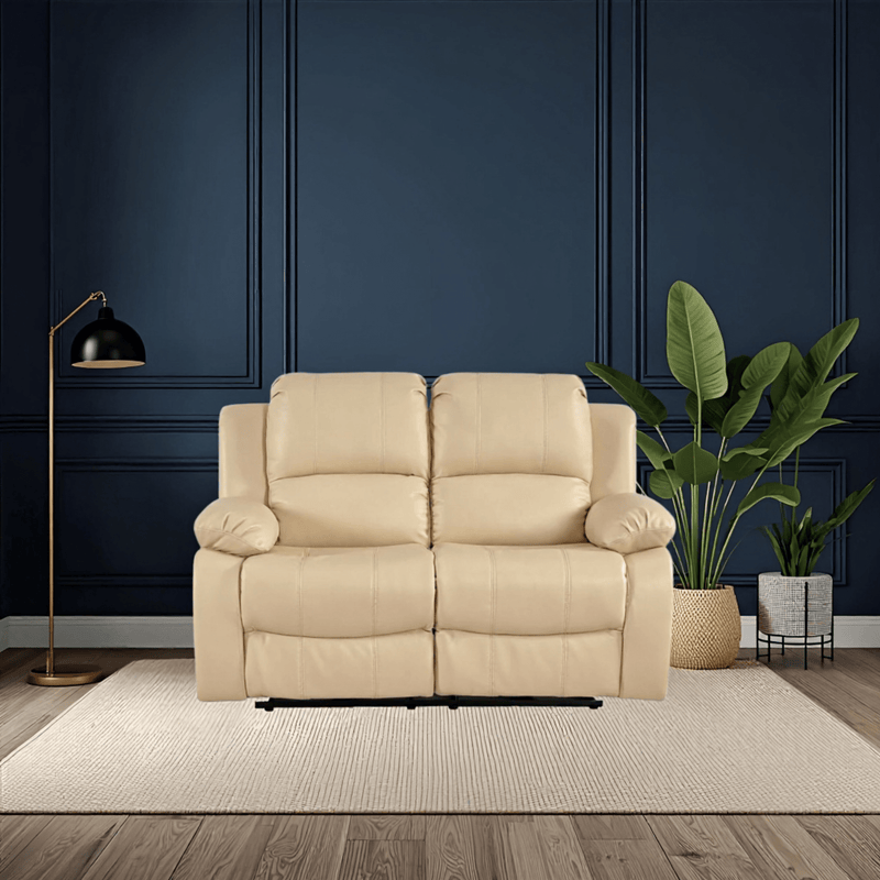 Beige sofa in a room with dark blue walls, a floor lamp, and plants.