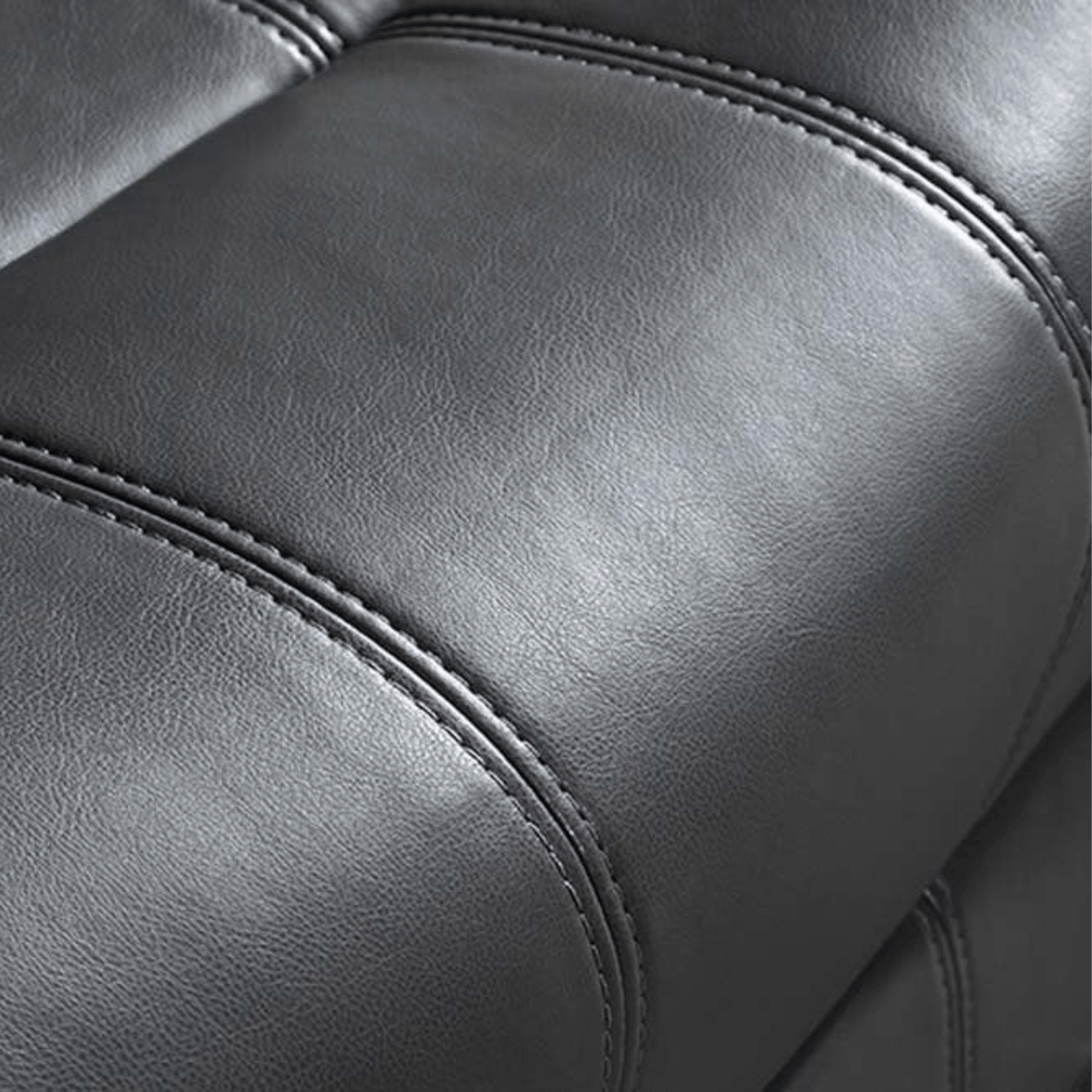 Close-up of a gray leather armchair with visible stitching