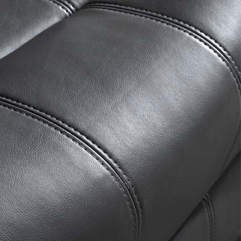 Close-up of a gray leather armchair with visible stitching