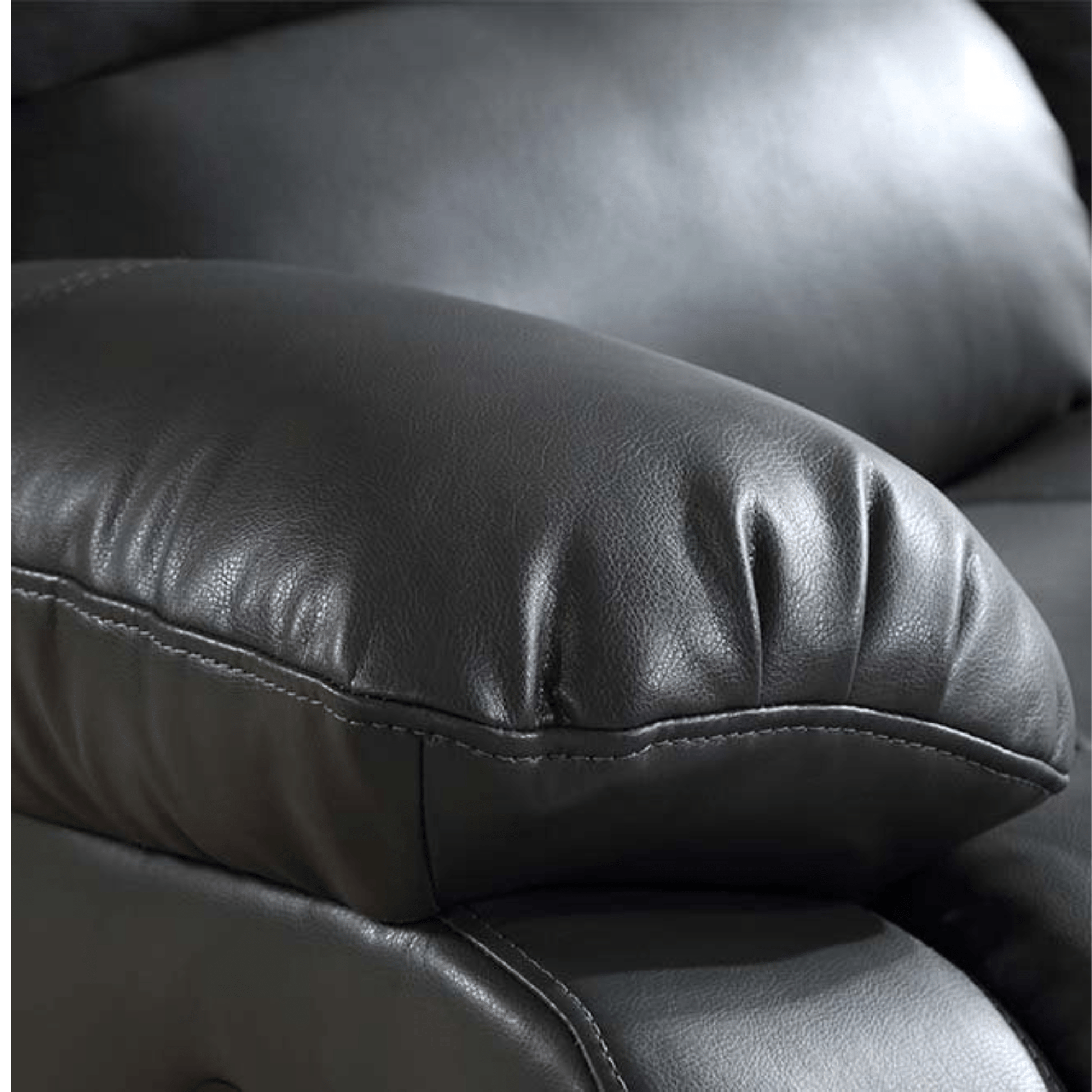 Close-up of a black leather armchair with visible stitching