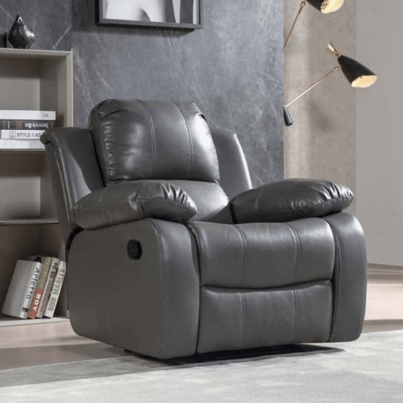 Gray recliner chair in a room with books and decor