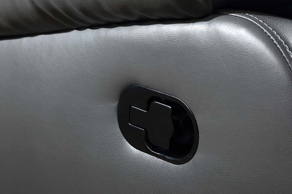 Close-up of a car door handle on a gray leather door panel.