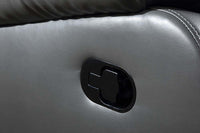 Close-up of a car door handle on a gray leather door panel.