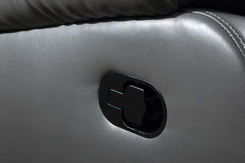 Close-up of a car door handle on a gray leather door panel.