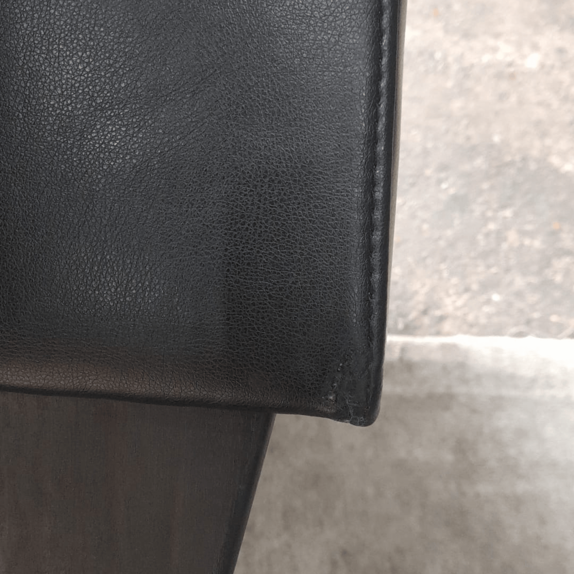 close up of edges of black leather sofa