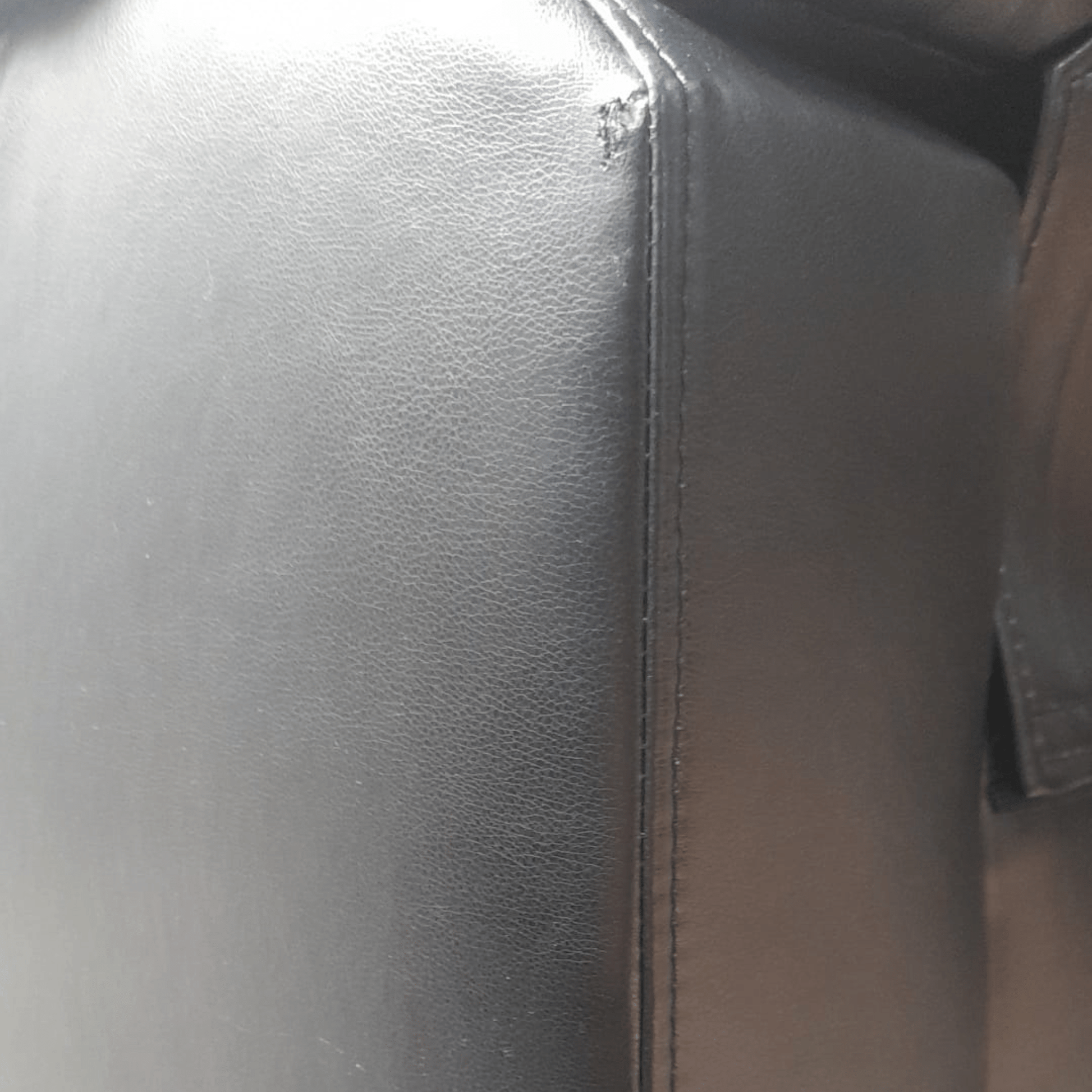 close up of leather black 3 seater sofa